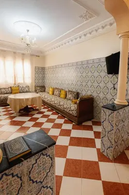 a living room with a couch and a checkered floor at Traditional Moroccan Apartment, Oulfa, Hajj Fateh in Casablanca