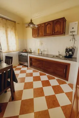 a kitchen with a checkered floor at Traditional Moroccan Apartment, Oulfa, Hajj Fateh in Casablanca