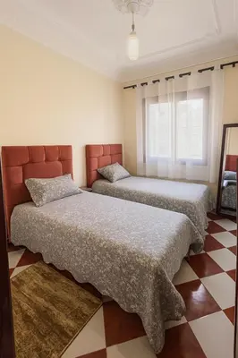 two beds sitting in a room with at Traditional Moroccan Apartment, Oulfa, Hajj Fateh in Casablanca