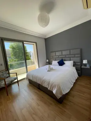 a bedroom with a large bed and a large window at Villa a darbouaza in Dar Bouazza