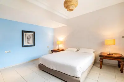 a bedroom with a large white bed and two lamps at Chic appartement in Casablanca in Casablanca