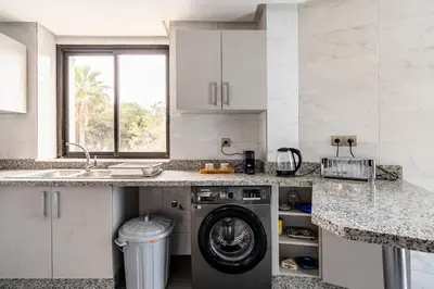a kitchen with a washing machine and a sink at Chic appartement in Casablanca in Casablanca