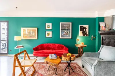 a living room with a red couch and green walls at Chic appartement in Casablanca in Casablanca