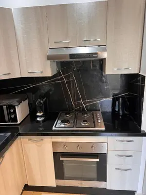 a kitchen with a stove and a microwave at Luxury apartment in Mansouria in Mansouria