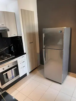 a kitchen with a stainless steel refrigerator and a stove at Luxury apartment in Mansouria in Mansouria