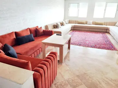 a living room with a couch and a table at Comfortable Apartment Maârif Area in Casablanca