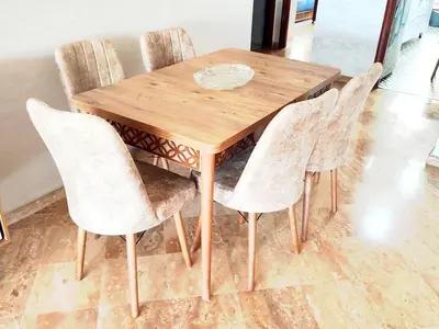 a wooden table with four chairs around it at Comfortable Apartment Maârif Area in Casablanca