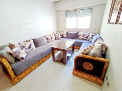 a living room with a couch and a table at Comfortable Apartment Maârif Area in Casablanca