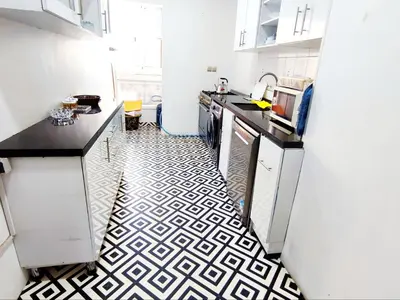 a kitchen with a black and white tile floor at Comfortable Apartment Maârif Area in Casablanca