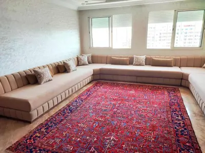 a living room with a large couch and a red rug at Comfortable Apartment Maârif Area in Casablanca