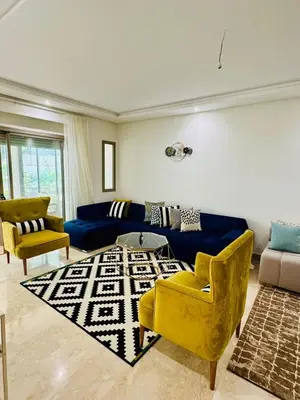 a living room with a blue couch and yellow chairs at Appartement Mer & Soleil à EL Mansoria in Pont Blondin