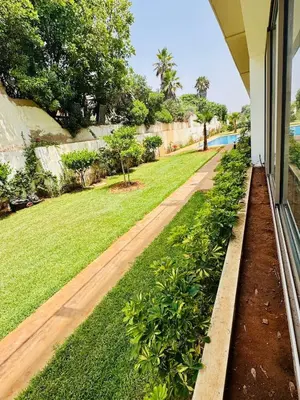 a view of a yard from the porch of a house at Appartement Mer & Soleil à EL Mansoria in Pont Blondin