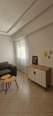 a living room with a couch and a coffee table at Séjour Idéal Piscine & Sécurité in Bouznika