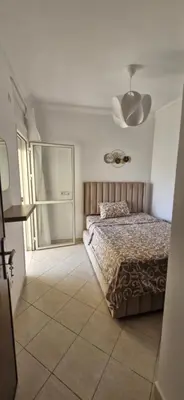a bedroom with a bed and a ceiling at Séjour Idéal Piscine & Sécurité in Bouznika