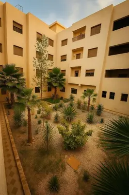 an apartment building with palm trees in front of it at Résidence calme 3 chambres pour votre hébergement in Bouznika