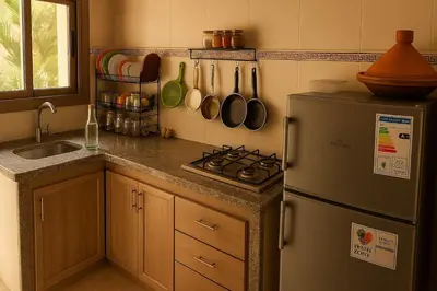 a kitchen with a refrigerator and a sink at Résidence calme 3 chambres pour votre hébergement in Bouznika