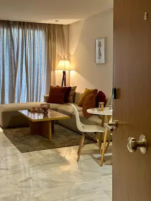 a living room with a couch and two tables at Studio chic Palmier in Casablanca