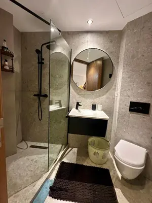 a bathroom with a shower and a toilet and a sink at Studio chic Palmier in Casablanca