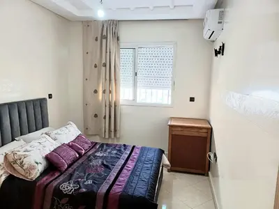 a bedroom with a bed and a window at Spacious Apartment Casablanca in Casablanca