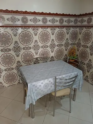 a table and chairs in front of a wall at Spacious Apartment Casablanca in Casablanca