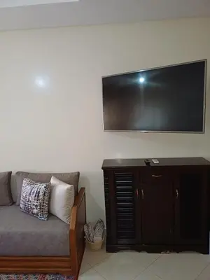 a living room with a couch and a flat screen tv at Spacious Apartment Casablanca in Casablanca