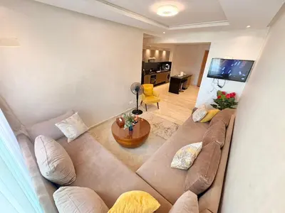 a living room with a couch and a table at cozy furnished studio fully equipped in Casablanca