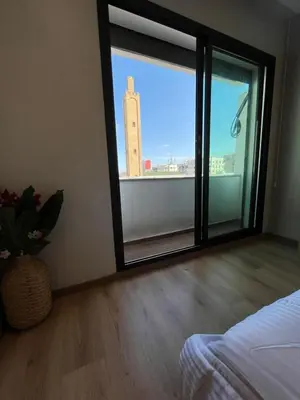 a bedroom with a window with a view of a building at cozy furnished studio fully equipped in Casablanca