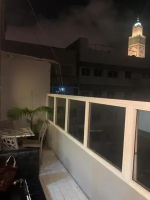 a balcony with a clock tower on top of a building at Studio Corniche Casablanca in Casablanca