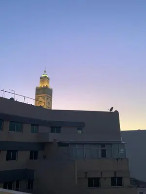 a building with a clock tower in the background at Studio Corniche Casablanca in Casablanca
