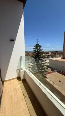 a room with a large window with a view of the ocean at Flat in Sidi Rahal Chatai with Ocean View in Sidi Rahal