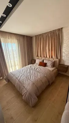 a bedroom with a large bed with a large window at Flat in Sidi Rahal Chatai with Ocean View in Sidi Rahal