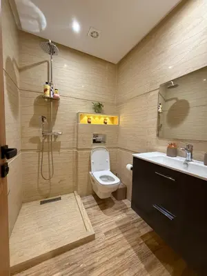 a bathroom with a shower and a toilet and a sink at Appartement Haut Standing vue Piscine in Sidi Rahal