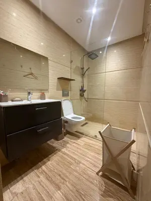 a bathroom with a toilet and a sink and a shower at Appartement Haut Standing vue Piscine in Sidi Rahal