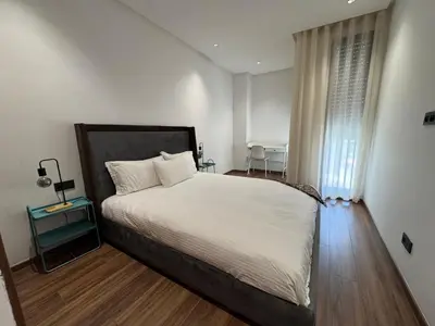 a bedroom with a large bed and a window at Modern Studio Princesses District in Maarif