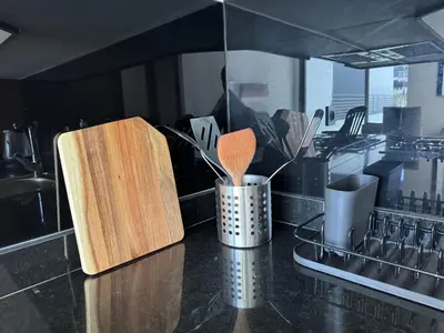 a kitchen counter with wooden cutting boards and utensils at Modern Studio Princesses District in Maarif
