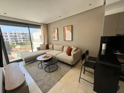 a living room with a couch and a table at Modern Studio Princesses District in Maarif