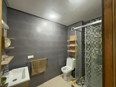 a bathroom with a toilet and a sink and a shower at Appartement Residence Mansbay - Piscine - Accès Plage - WIFI in Mohammedia