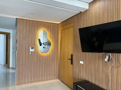 a room with a guitar on the wall at Appartement Residence Mansbay - Piscine - Accès Plage - WIFI in Mohammedia