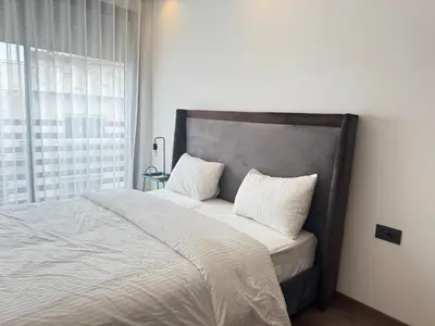 a bed with two pillows on it in a bedroom at Élégant Studio Neuf Quartier 2 Mars Sécurisé in Aïn Chock