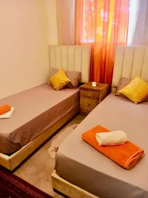 a room with two beds and a window at Plage à Pied Refuge Relaxant Design Moderne in Tamaris
