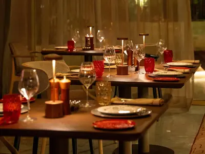 a table with wine glasses and plates on it at STORY Le Carrousel Rabat in Rabat