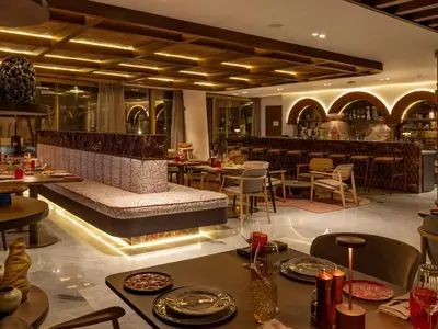 a restaurant with a bench in the middle of a room at STORY Le Carrousel Rabat in Rabat