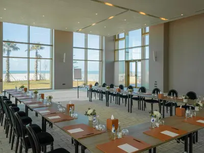 a conference room with tables and chairs and large windows at STORY Le Carrousel Rabat in Rabat