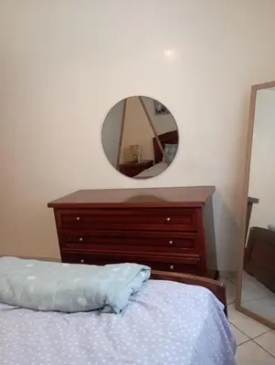a bedroom with a bed and a dresser with a mirror at SUMMER AND FAMILY APPARTEMMENT ,mouhamadia in Mohammedia