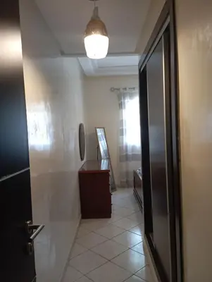a hallway with a bathroom with a mirror and a door at SUMMER AND FAMILY APPARTEMMENT ,mouhamadia in Mohammedia