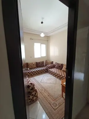 a living room with a couch and a window at SUMMER AND FAMILY APPARTEMMENT ,mouhamadia in Mohammedia
