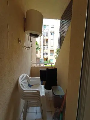 a room with two white chairs and a table at SUMMER AND FAMILY APPARTEMMENT ,mouhamadia in Mohammedia