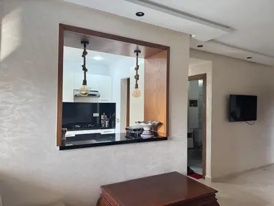 a mirror on the wall of a living room at Les perles de tamaris in Casablanca