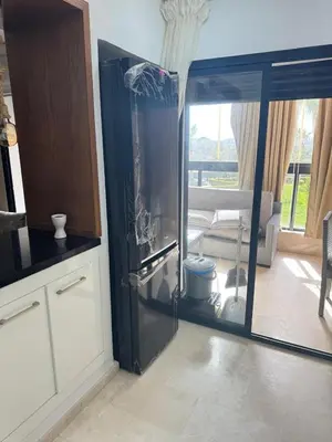 a kitchen with a glass door to a living room at Les perles de tamaris in Casablanca