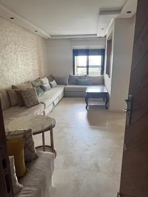 a living room with a couch and a table at Les perles de tamaris in Casablanca